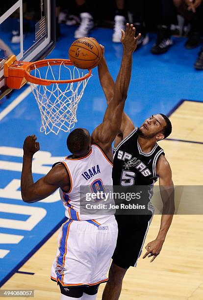 Cory Joseph of the San Antonio Spurs dunks on Serge Ibaka of the Oklahoma City Thunder in the second half during Game Four of the Western Conference...