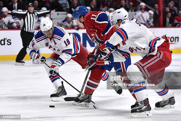 Brendan Gallagher of the Montreal Canadiens fights for the puck against Marc Staal and Anton Stralman of the New York Rangers in Game Five of the...