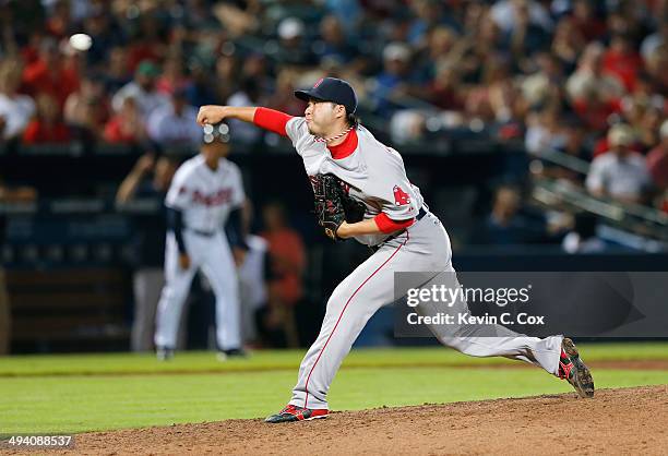 Junichi Tazawa of the Boston Red Sox pitches in the seventh inning to the Atlanta Braves at Turner Field on May 27, 2014 in Atlanta, Georgia.