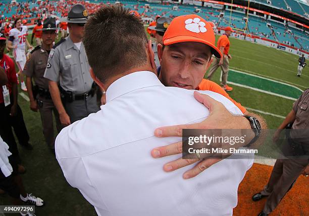 Head coach Al Golden of the Miami Hurricanes and head coach Dabo Swinney of the Clemson Tigers shake hands after a game at Sun Life Stadium on...