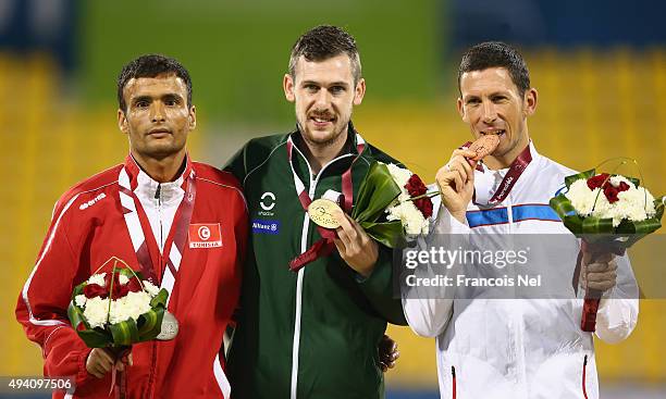 Michael McKillop of Ireland poses with his gold, Abbes Saidi of Tunisia silver and Louis Radius of France bronze after the men's 800m T38 final...