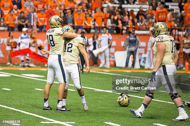 Ryan Winslow congratulates Chris Blewitt of the Pittsburgh Panthers for kicking the game winning field goal at the end of the fourth quarter against...