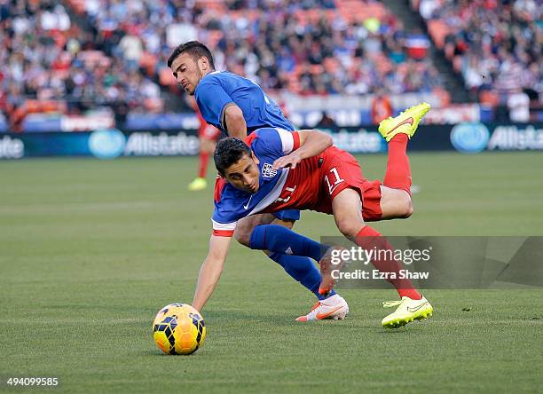 Alejandro Bedoya of the United States and Gara Garayev of Azerbaijan go for the ball during their match at Candlestick Park on May 27, 2014 in San...