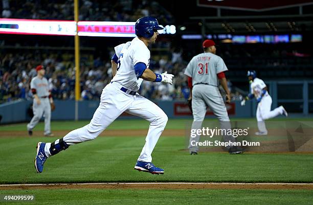 Andre Ethier of the Los Angeles Dodgers runs to first on his three run triple in the fourth inning of of pitcher Alfredo Simon of the Cincinnati Reds...