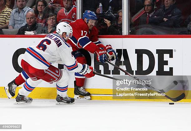 Rene Bourque of the Montreal Canadiens plays the puck against Anton Stralman of the New York Rangers during Game Five of the Eastern Conference Final...