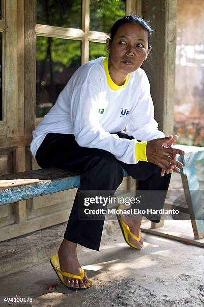 Erwiana's mother named Suratmi relaxes in front of her home on May 27, 2014 in Ngawi, Indonesia. Erwiana has been voted one of 100 most influential...
