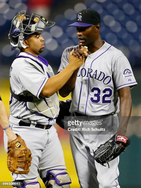 Wilin Rosario of the Colorado Rockies congratulates pitcher LaTroy Hawkins after a win over the Philadelphia Phillies 6-2 at Citizens Bank Park on...