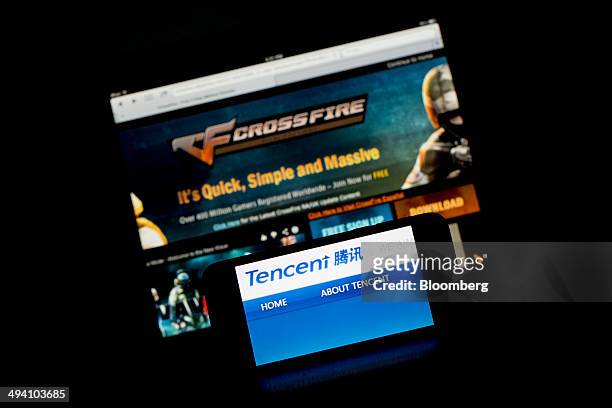 The website for CrossFire, an online game developed by SmileGate Holdings and published by Tencent Holdings Ltd. In China, is displayed on an Apple...
