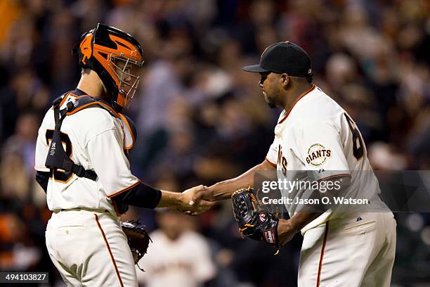 Catcher Buster Posey of the San Francisco Giants celebrates with Jean Machi after the game against the Chicago Cubs at AT&T Park on May 27, 2014 in...