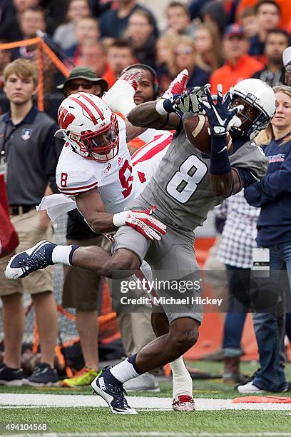 Geronimo Allison of the Illinois Fighting Illini makes a catch as Sojourn Shelton of the Wisconsin Badgers defends at Memorial Stadium on October 24,...