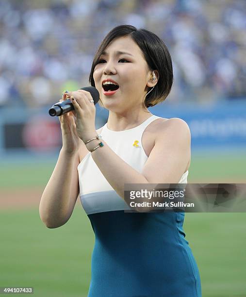 Korean singer Cho Yong Jin, aka ALi sings the national anthem before the game between the Los Angeles Dodgers and Cincinnati Reds on May 27, 2014 in...