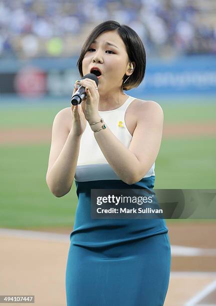 Korean singer Cho Yong Jin, aka ALi sings the national anthem before the game between the Los Angeles Dodgers and Cincinnati Reds on May 27, 2014 in...