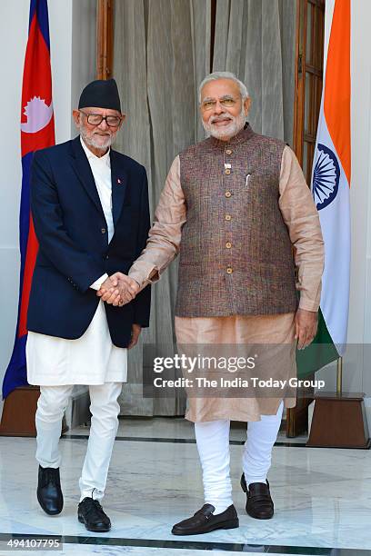 Nepal Prime Minister Sushil Koirala shakes hands with Prime Minister Narendra Modi after the swearing-in ceremony of the NDA government in New Delhi...