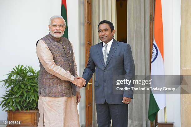 Maldivian President Abdulla Yameen Abdul Gayoom shakes hands with Prime Minister Narendra Modi after the swearing-in ceremony of the NDA government...