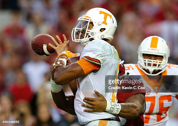 Ryan Anderson of the Alabama Crimson Tide forces a turnover as he tackes Joshua Dobbs of the Tennessee Volunteers in the final seconds of their 19-14...