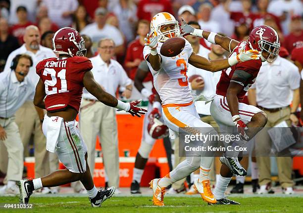 Josh Malone of the Tennessee Volunteers pulls in this reception against Maurice Smith and Marlon Humphrey of the Alabama Crimson Tide at Bryant-Denny...