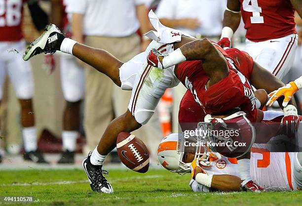 Maurice Smith of the Alabama Crimson Tide attempts to force a fumble as he strips the ball from Josh Malone of the Tennessee Volunteers at...