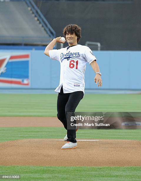 Former Los Angeles Dodger pitcher Chan Ho Park throws out the ceremonial first pitch before the game between the Los Angeles Dodgers and Cincinnati...