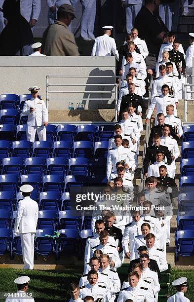 Graduates walk in procession at the beginning of the United States Naval Academy graduation and commissioning ceremony at Navy-Marine Corps Memorial...