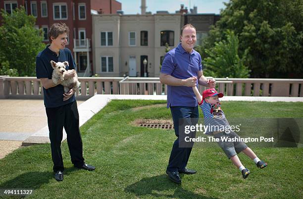 United States Representative Jared Polis , right center, spins his son, Caspian as they pose for a portrait along with Polis' partner, Marlon Reis,...