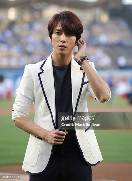 Korean singer Jung Yong-hwa waits to sing the Korean national anthem before the game between the Los Angeles Dodgers and Cincinnati Reds on May 27,...