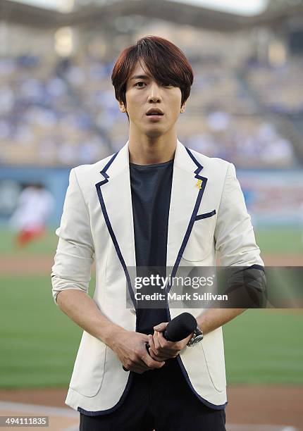 Korean singer Jung Yong-hwa waits to sing the Korean national anthem before the game between the Los Angeles Dodgers and Cincinnati Reds on May 27,...