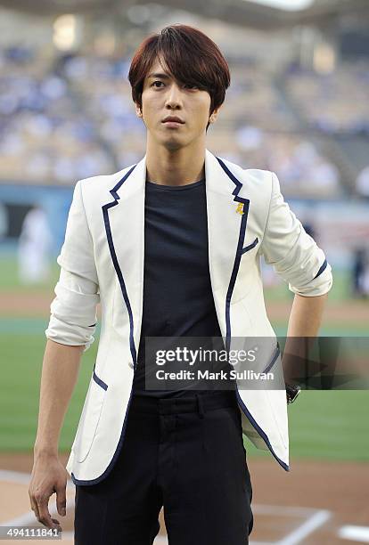 Korean singer Jung Yong-hwa waits to sing the Korean national anthem before the game between the Los Angeles Dodgers and Cincinnati Reds on May 27,...