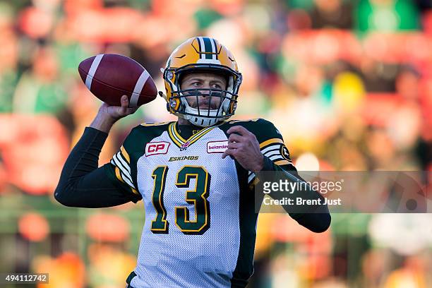 Mike Reilly of the Edmonton Eskimos throws a pass in the first half of the game between the Edmonton Eskimos and Saskatchewan Roughriders in week 18...