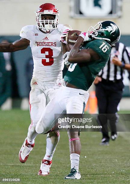 Aaron Burbridge of the Michigan State Spartans catches a 28-yard pass against Tyler Green of the Indiana Hoosiers during the second half at Spartan...