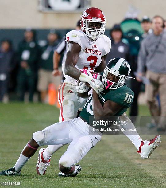 Aaron Burbridge of the Michigan State Spartans catches a 28-yard pass against Tyler Green of the Indiana Hoosiers during the second half at Spartan...