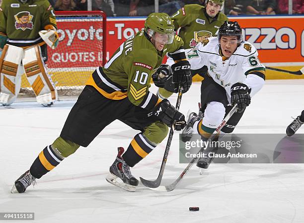 Brett Hargrave of the North Bay Battalion skates away from a checking Kole Sherwood of the London Knights during an OHL game at Budweiser Gardens on...