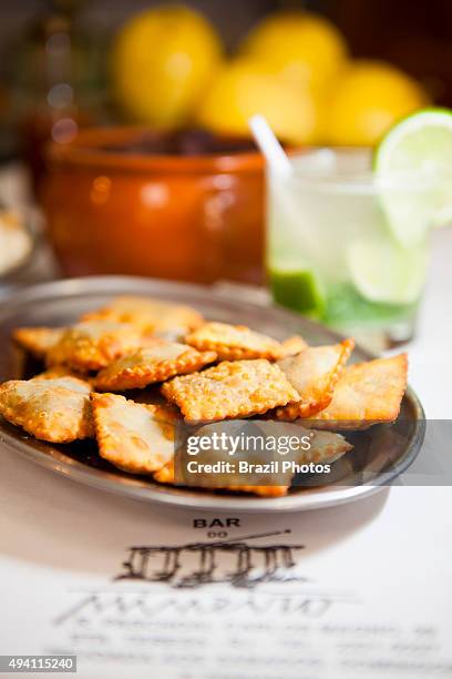 Bean pies and caipirinha served at Bar do Mineiro, Santa Teresa quarter, Rio de Janeiro, Brazil.