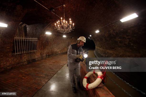 Worker of the urban drainage company walks through the so-called candelabra hall of the canalisation system of the city of Cologne, western Germany,...