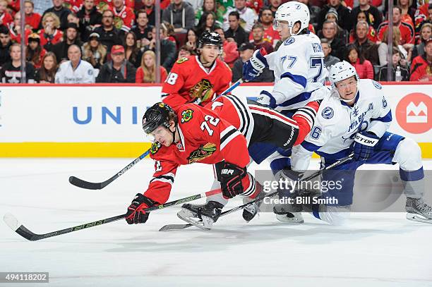 Artemi Panarin of the Chicago Blackhawks falls over Anton Stralman of the Tampa Bay Lightning in the third period of the NHL game at the United...