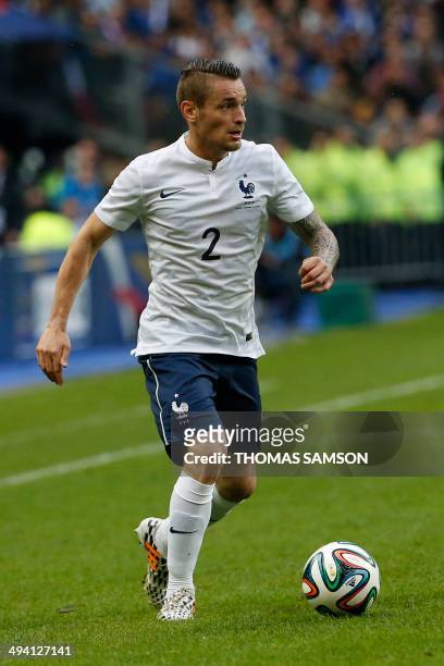 France's defender Mathieu Debuchy runs with the ball during a friendly football match between France and Norway at the Stade de France in Saint-Denis...