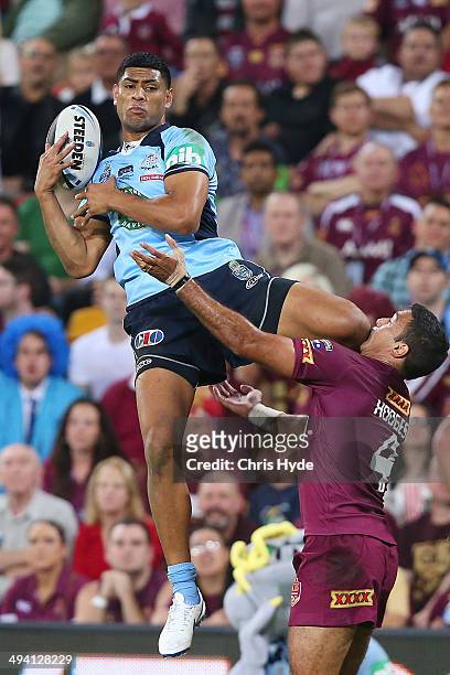 Daniel Tupou of the Blues takes a high ball over Justin Hodges of the Maroons during game one of the State of Origin series between the Queensland...