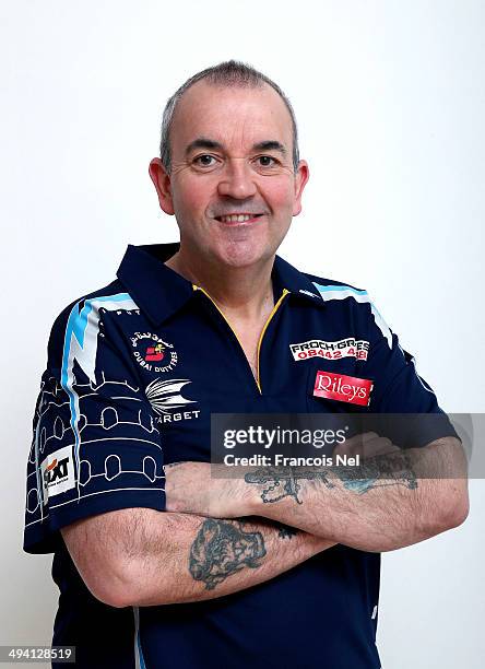 Phil Taylor of England poses for a portrait prior to the start of the draw ceremony for the Dubai Duty Free Darts Masters to reveal the Quarter Final...