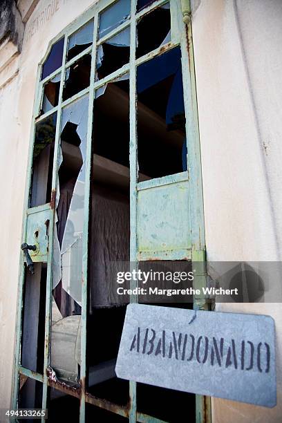 Sign with the word 'Abandonado', Portuguese for abandoned, hangs on a grave at the graveyard Cemiterio dos Prazeres on September 14, 2011 in Lisbon,...