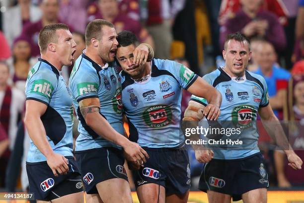 Trent Hodkinson, Trent Merrin, Jarryd Hayne and Josh Reynolds of the Blues celebrate after winning game one of the State of Origin series between the...