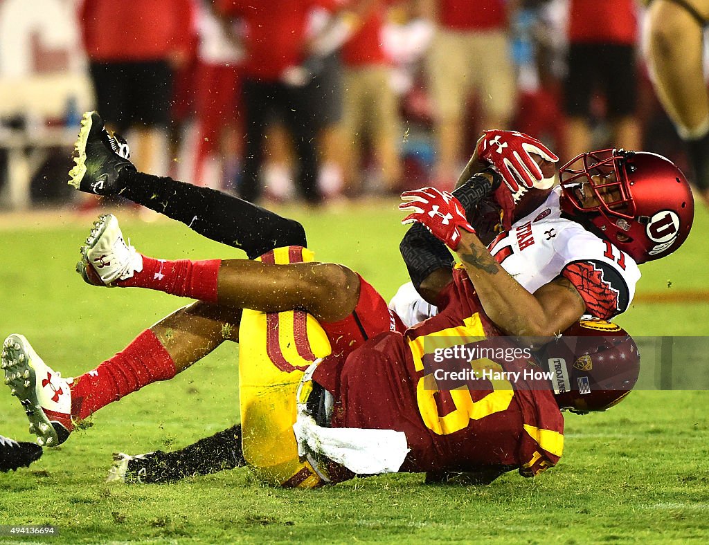 Raelon Singleton of the Utah Utes is tackled by Kevon Seymour of