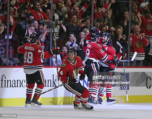 Brent Seabrook of the Chicago Blackhawks hugs teammate Jonathan Toews after Toews scored the game-winning goal against the Tampa Bay Lightning as...