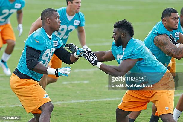 Dion Jordan and Terrence Fede of the Miami Dolphins participate in drills during the teams first OTA on May 27, 2014 at the Miami Dolphins training...