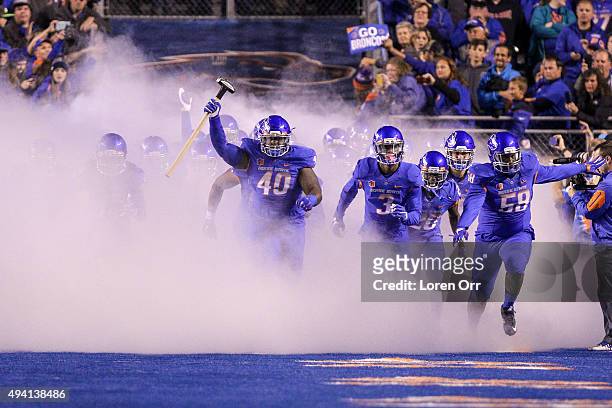 Defensive tackle Armand Nance of the Boise State Broncos carries the hammer and leads the Boise State Broncos out to start the game against the...