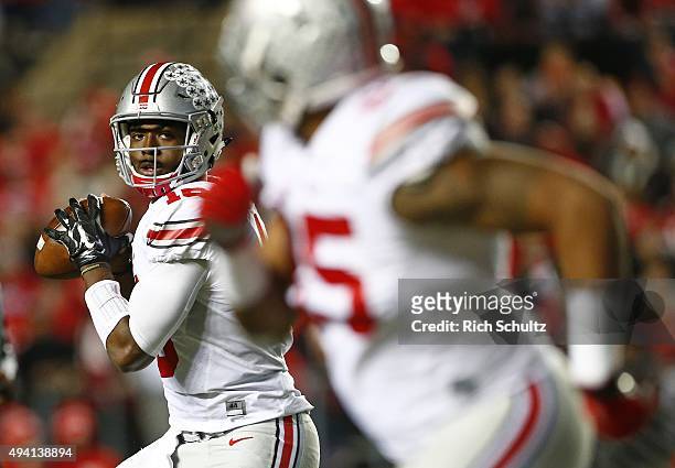 Quarterback J.T. Barrett of the Ohio State Buckeyes looks to pass to Marcus Baugh during the second quarter against the Rutgers Scarlet Knights at...