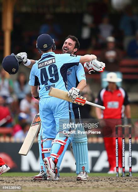 Steve Smith and Ed Cowan of the Blues celebrate after hitting the winning runs during the Matador BBQs One Day Cup final match between New South...