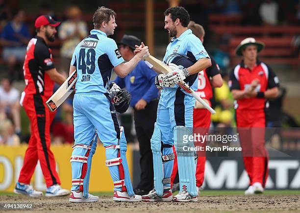 Steve Smith and Ed Cowan of the Blues celebrate after hitting the winning runs during the Matador BBQs One Day Cup final match between New South...