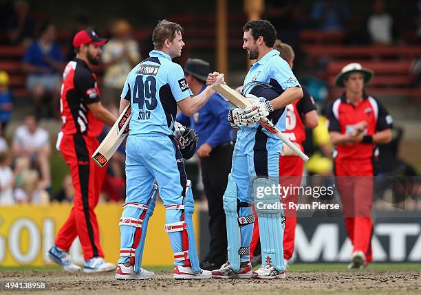 Steve Smith and Ed Cowan of the Blues celebrate after hitting the winning runs during the Matador BBQs One Day Cup final match between New South...