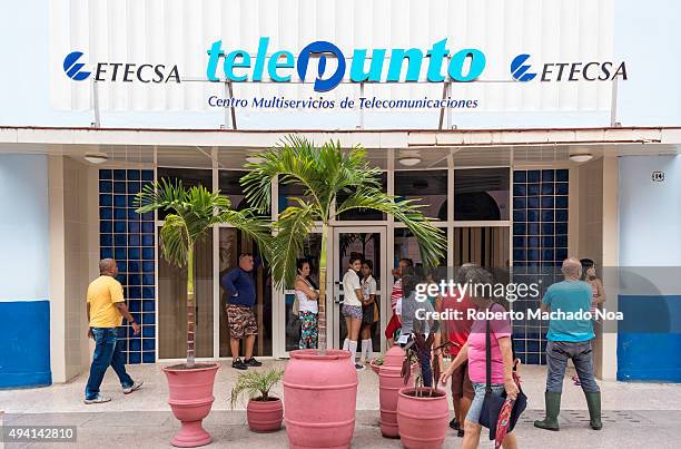 People waiting outside the Telepoint of ETECSA in Sancti Spiritus, Cuba. Empresa de Telecomunicaciones de Cuba S.A. Is a government owned telephone,...