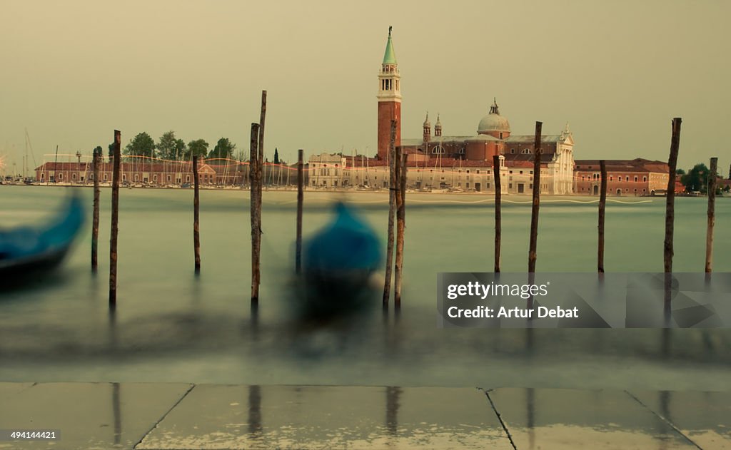 Venice canal with gondolas and Giorgio Maggiore.