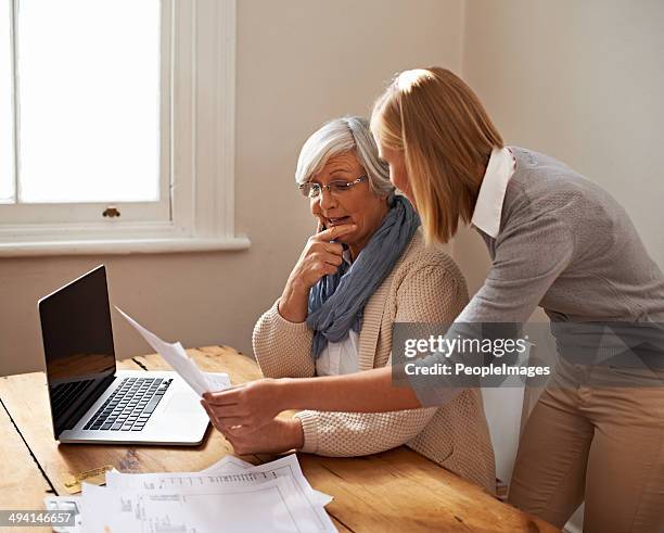 taking some time to help her grandmother - grandma invoice bildbanksfoton och bilder